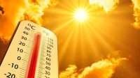 hot temperature,Thermometer on yellow sky with sun shining